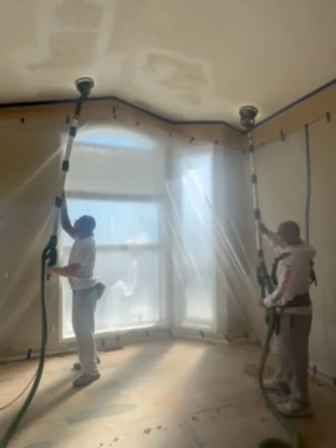 The Chamos crew sanding a protected ceiling.